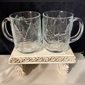 2 Luminarc holiday mugs. “Through the Woods”